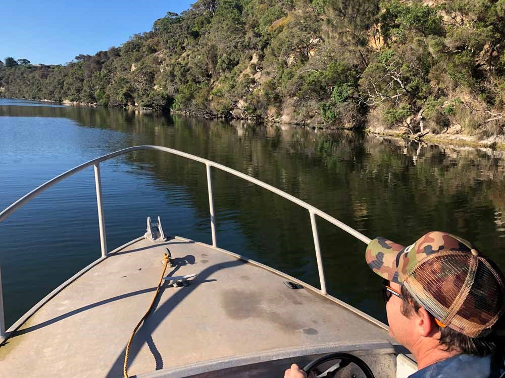 A photo of a man driving a boat on the river during the Vic Bream Classic